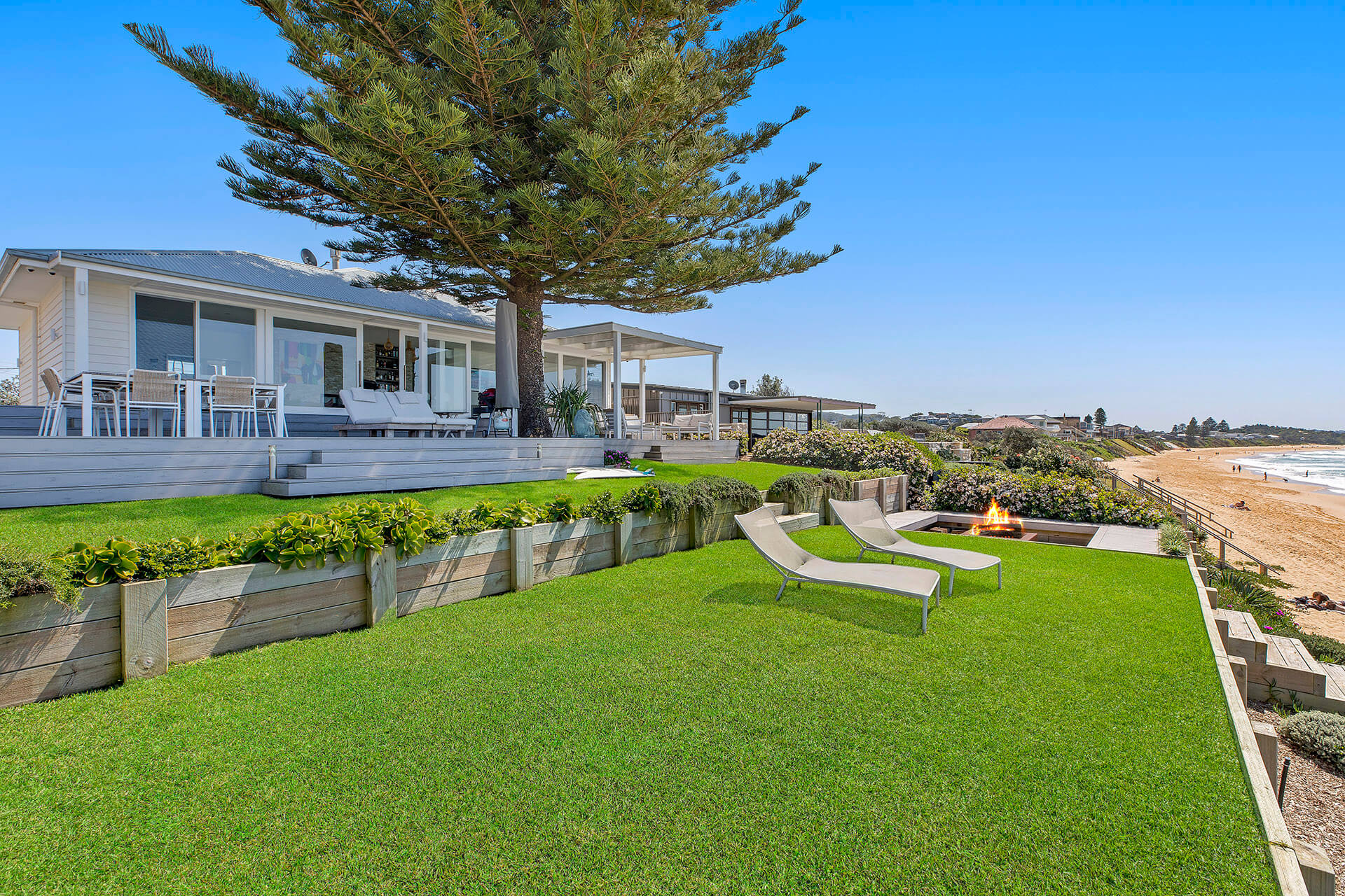 Beach home with large tree and flat grass area