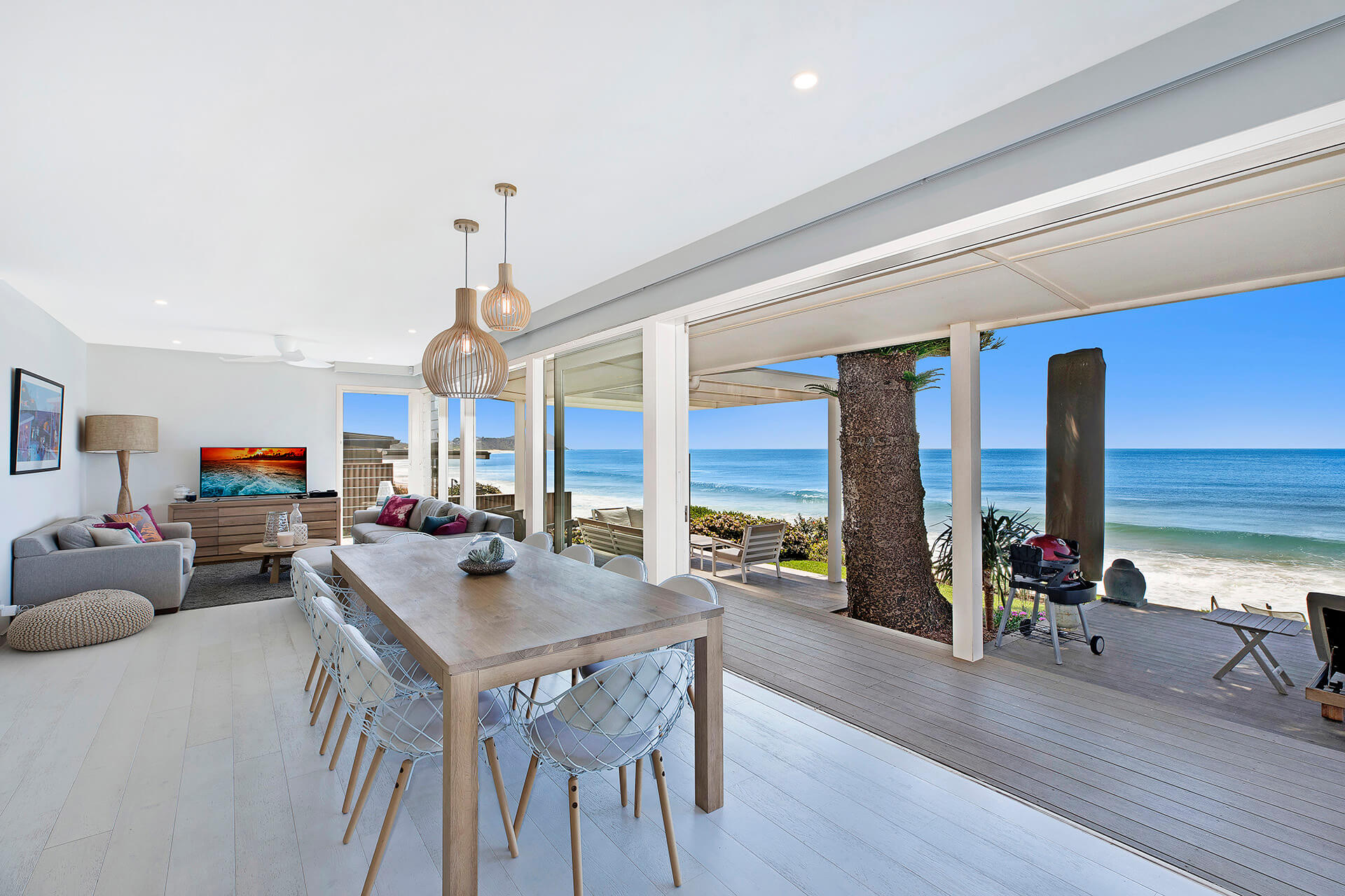 Open living space in beach home with ocean in the background