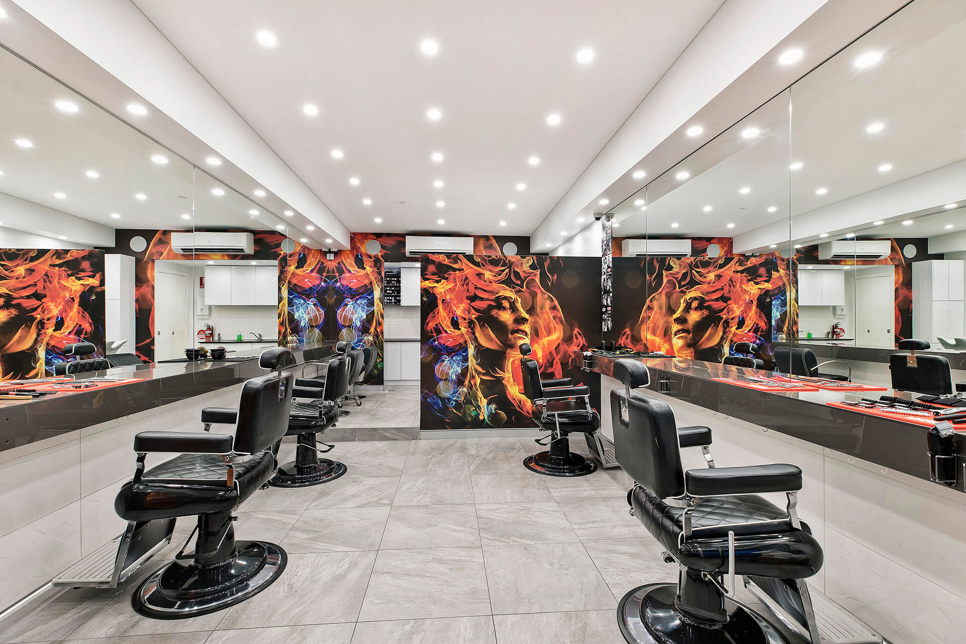 White barber shop with artwork on furthest wall