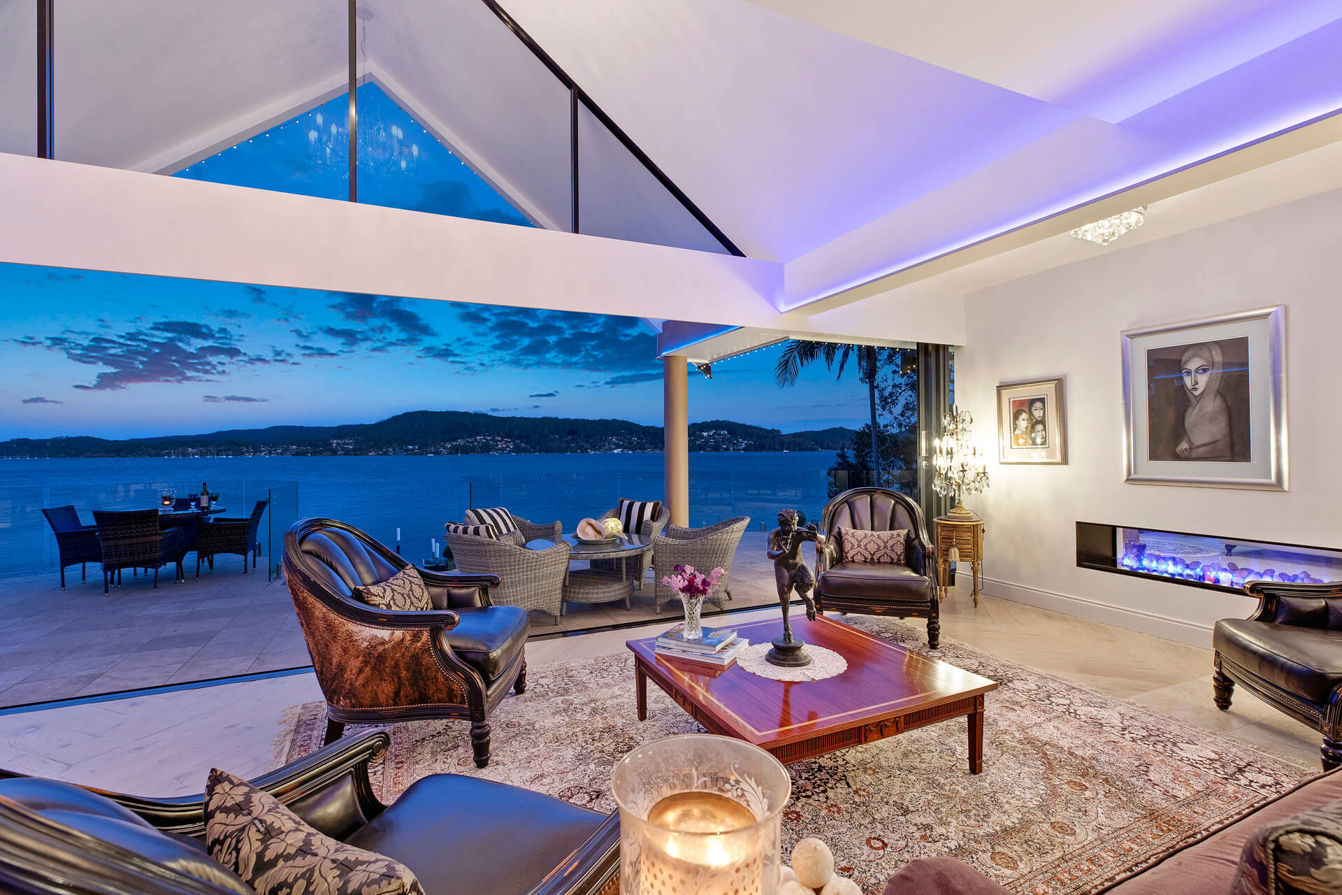Open living space with lake in background during the evening